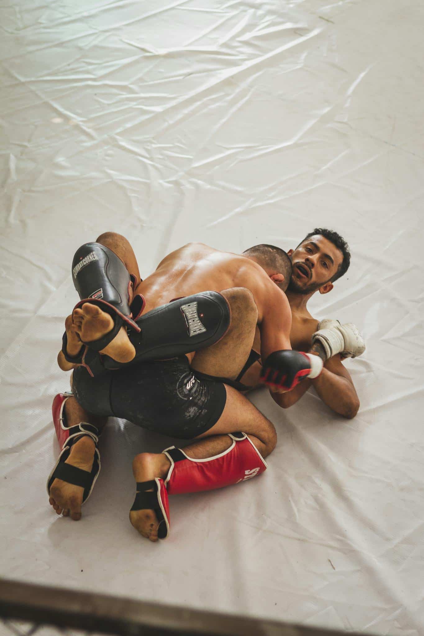 photo of mma fighters grappling with wearing sweaty gear